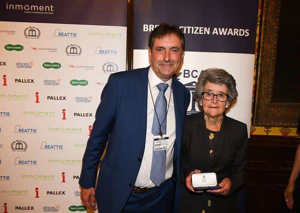 Peggy Bainbridge with her pair of awards