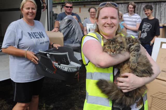 Cats Protection volunteer Amanda Broome, holding her cat Cinders, and friends with the Zooplus donation