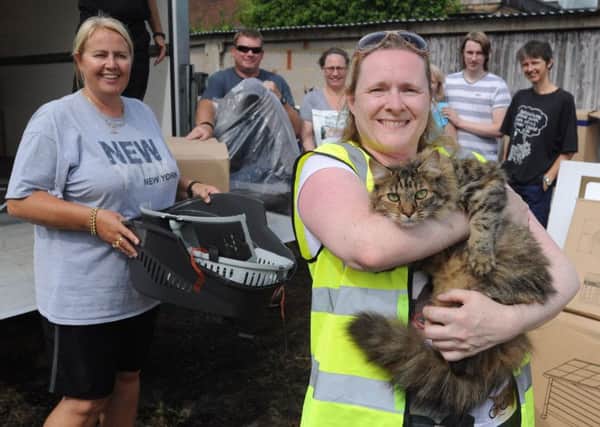 Cats Protection volunteer Amanda Broome, holding her cat Cinders, and friends with the Zooplus donation