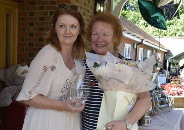 Margaret Gilbert receives her gifts from care home manager Diane Delicate