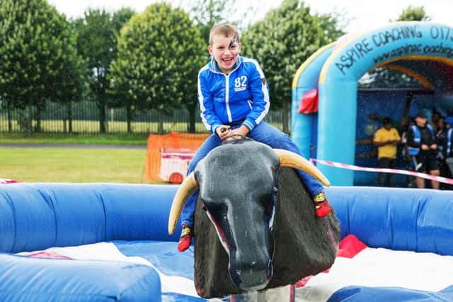 Amazon's Summer BBQ at Herts County Showground. Hubertas, seven, (son of Elena Vicius) rides the rodeo.