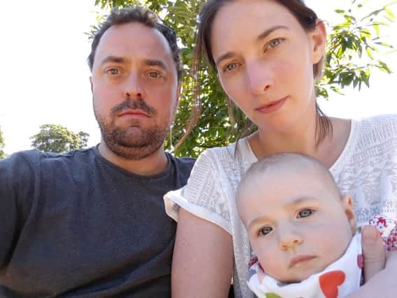 Teacher Ashley Purser, left, and wife Kate with their baby daughter Margot