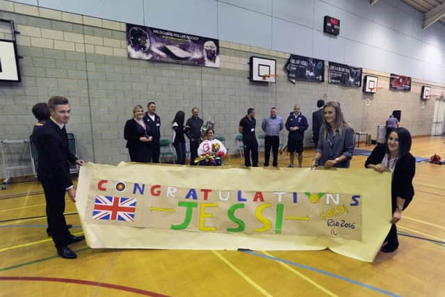 Jess Stretton at morning assembly at Longdean School, Hemel Hempstead.Withe the banner from left, head boy Adam Hatchett, school chair Lydia Clark and deputy head girl Emily Rogers.