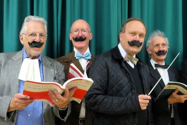 Members of the Aeolian Singers wear false moustaches as they rehearse for a performance of Elgars dramatic oratorio The Dream of Gerontius