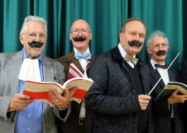 Members of the Aeolian Singers wear false moustaches as they rehearse for a performance of Elgars dramatic oratorio The Dream of Gerontius
