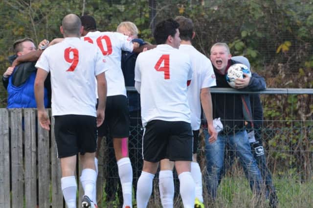 Players celebrate with young fans. Picture: Chris Riddell