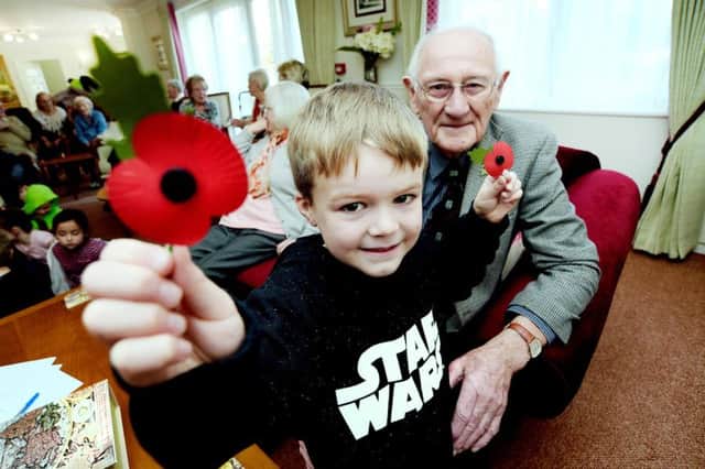 St Thomas More School children visit the residents at Sheldon Lodge to remember the fallen from the world wars and plant crocuses in the gardens.
Josh Smith, 6, with resident David Williamson. PNL-161117-172305001