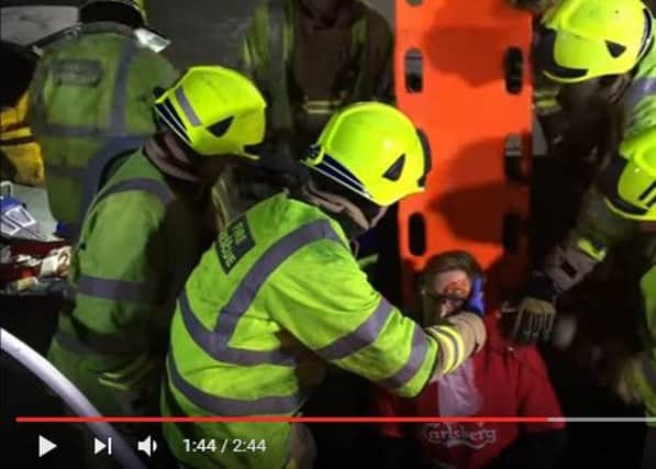 Firefighters stage a crash rescue for the music video