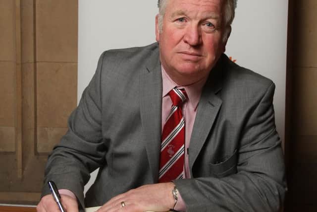 Mike Penning MP signs the Book of Commitment