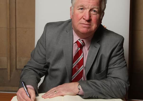Mike Penning MP signs the Book of Commitment
