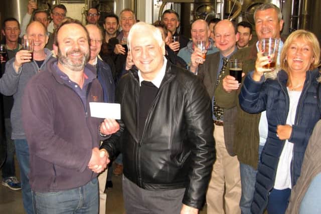 Andrew Jackson (left) presents the £2,400 cheque to Mike Nevin, of the de Havilland Aircraft Museum