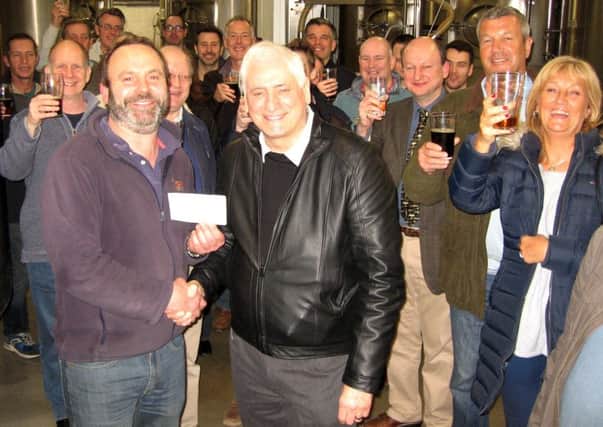 Andrew Jackson (left) presents the Â£2,400 cheque to Mike Nevin, of the de Havilland Aircraft Museum