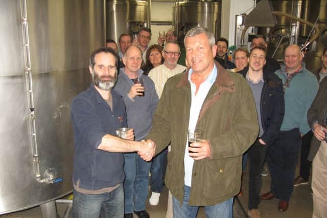 Competition winner Julian Tunks, right, is congratulated by the brewery's Ben Marston