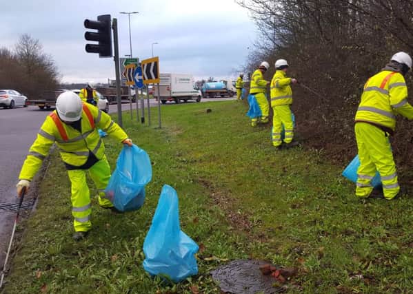 Council workers clear rubbish from the A41 in Dacorum