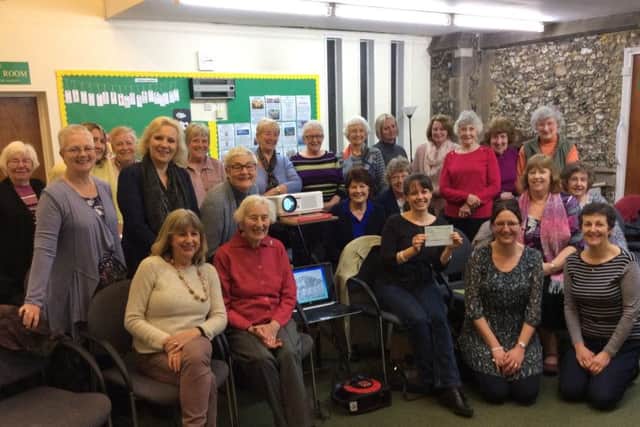 Nicole Fidler receives the cheque from Trinity Women's Group