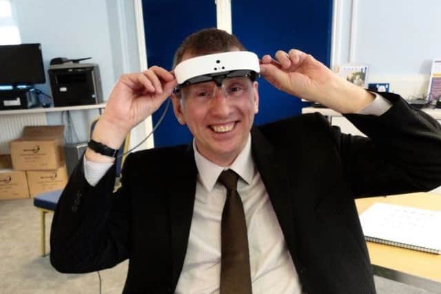 Brian tries on the eSight headtest which restored his vision