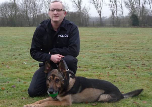 Police dog Finn alongside his handler PC Dave Wardell