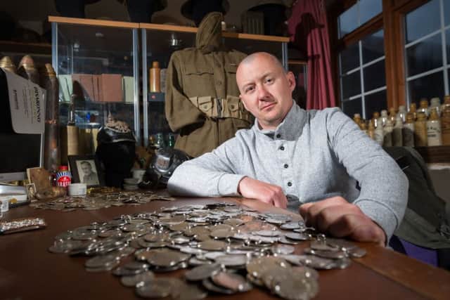 Dan Mackay, 37, discovered the military tags under the earth beside the site of a World War Two anti-aircraft battery just outside London. Photo: SWNS