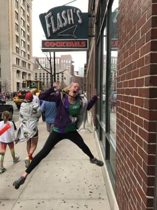 Ania Gabb jumps for joy with her Boston Marathon medal