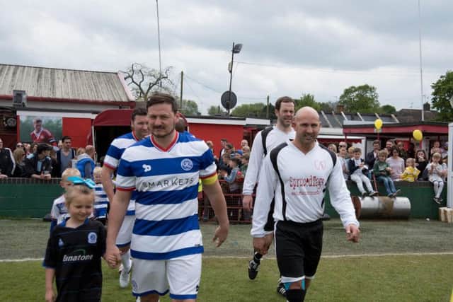 The teams are led out by the captains