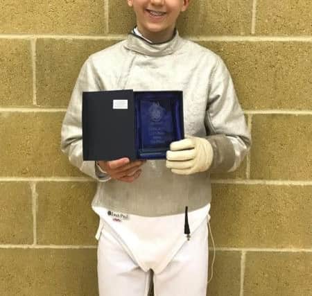 Eleven-year-old Freddie Ford with his IAPS medal
