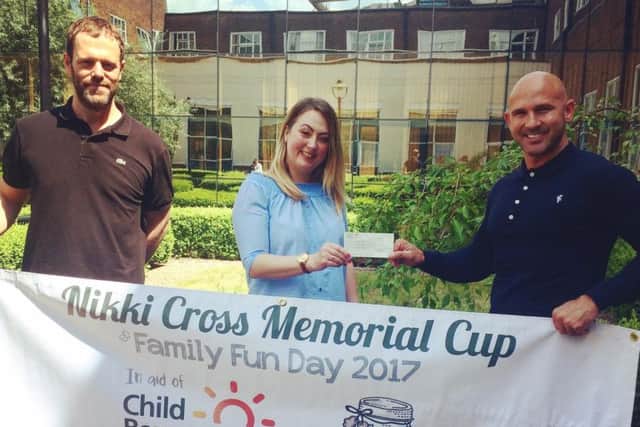 A cheque is presented to CB UK on behalf of Nikki's Wishes