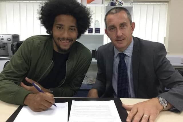 Jorell Johnson with chairman Jeremy Wilkins after signing his new deal