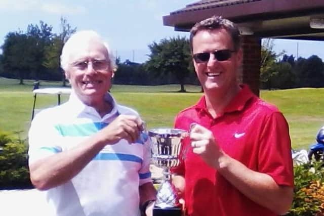 Little Hay GC club captain Trevor Sargent presents Fraser Welling, right, with the Past Captains summer trophy