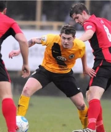 Taylor Miles, in yellow, during his loan spell at Boston United