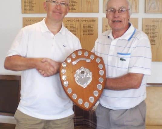 Steven Crowhurst, left, is presented with the Ron Gingell Shield by Little Hay Golf Club club captain Trevor Sargent