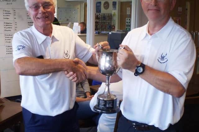 Little Hay GC club captain Trevor Sargent, left, presents Captains Day winner Steven  Crowhurst with the Captains Cup  trophy