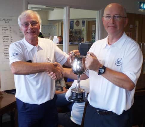 Little Hay GC club captain Trevor Sargent, left, presents Captains Day winner Steven  Crowhurst with the Captains Cup  trophy