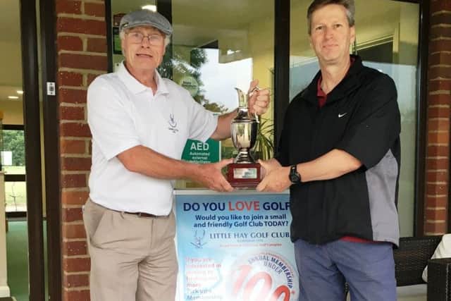 Little Hay GC club captain Trevor Sargent, left, presents Jerry Clark with the Summer League Cup.