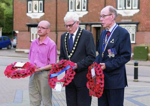 Mark Betton, Mayor Gerald Wilkins and Sir Michael Simmons lay a wreath at the memorial in Tring. Picture by Stephen Kitchener