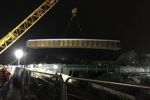 The bridge is lifted into place over Featherbed Lane