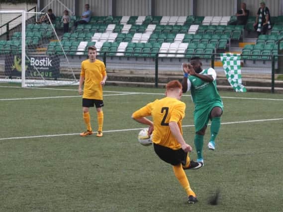 Zak Howells crosses the ball for Leverstock Green against Edgware