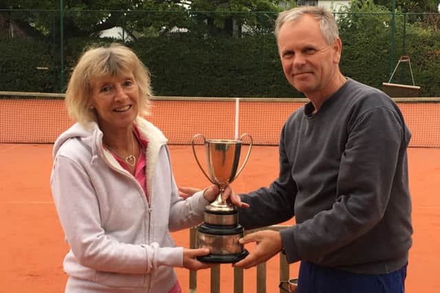 Ladies singles winner Maria Lawton is presented with the trophy by  club chairman Neil Morgan