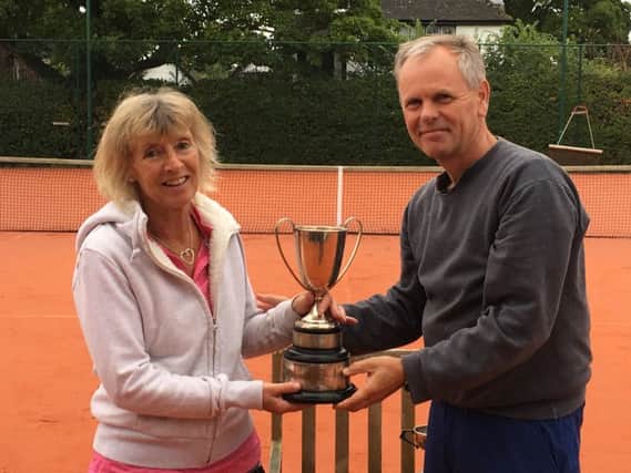 Ladies singles winner Maria Lawton is presented with the trophy by  club chairman Neil Morgan